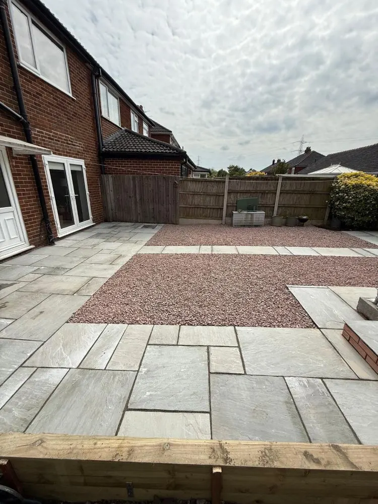 Sandstone patio with red gravel and sleeper edge