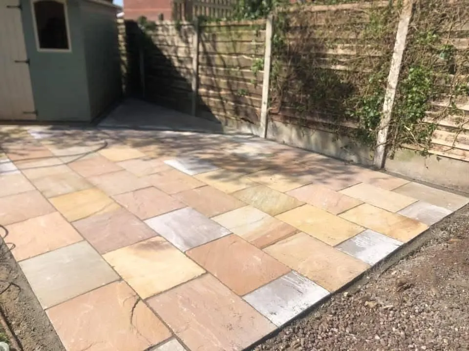 Buff sandstone path along a fence