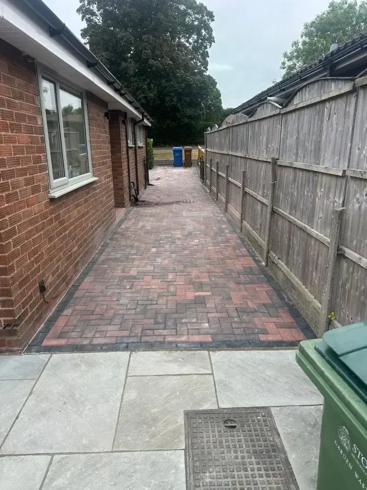Block paved side path to sandstone patio
