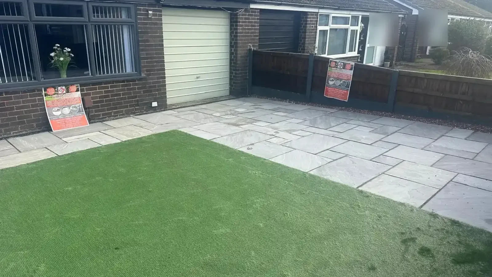 Artificial lawn and sandstone patio at a bungalow
