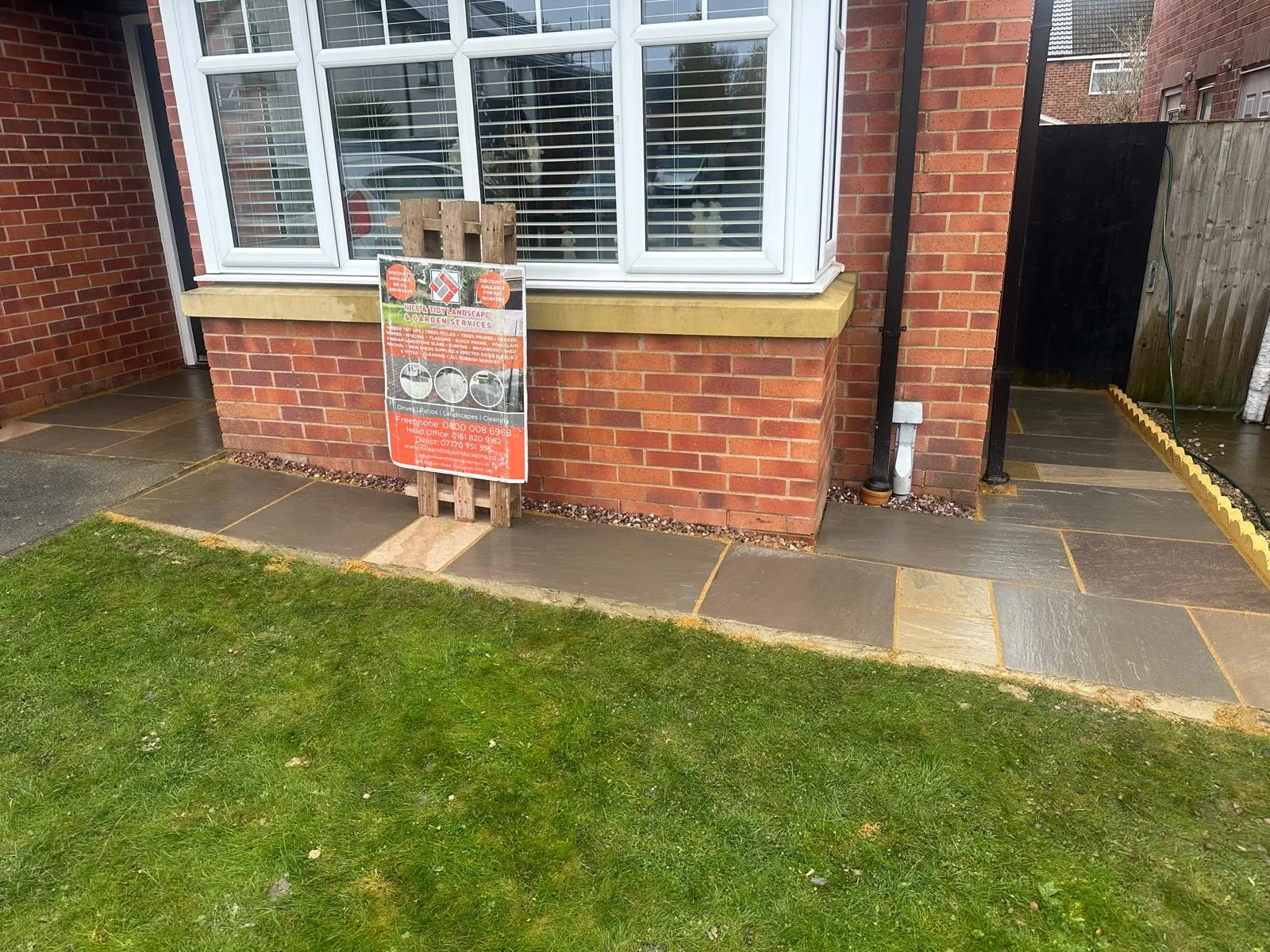 Sandstone front path beside a lawn