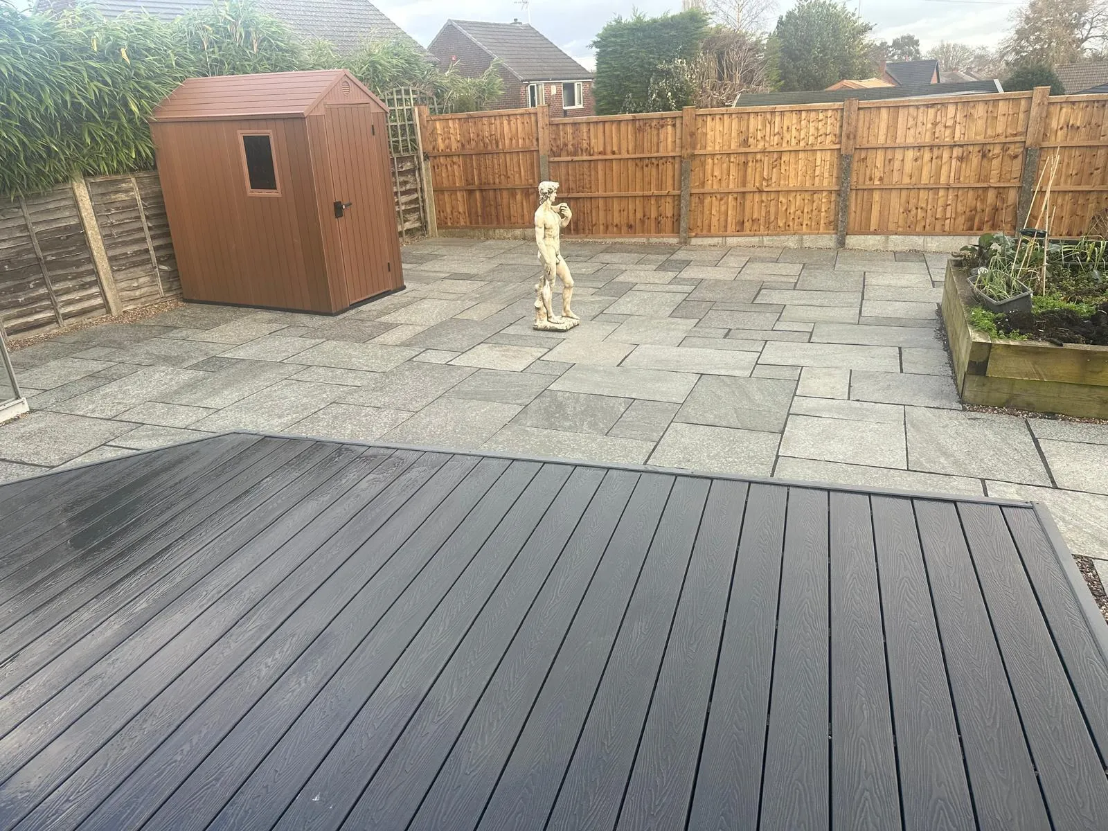 Composite deck beside a sandstone patio