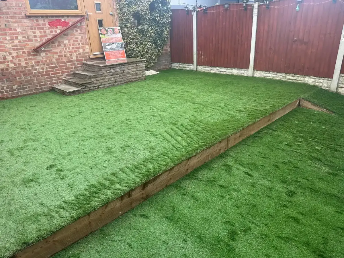 Artificial grass laid on two levels with a sleeper edge in Manchester