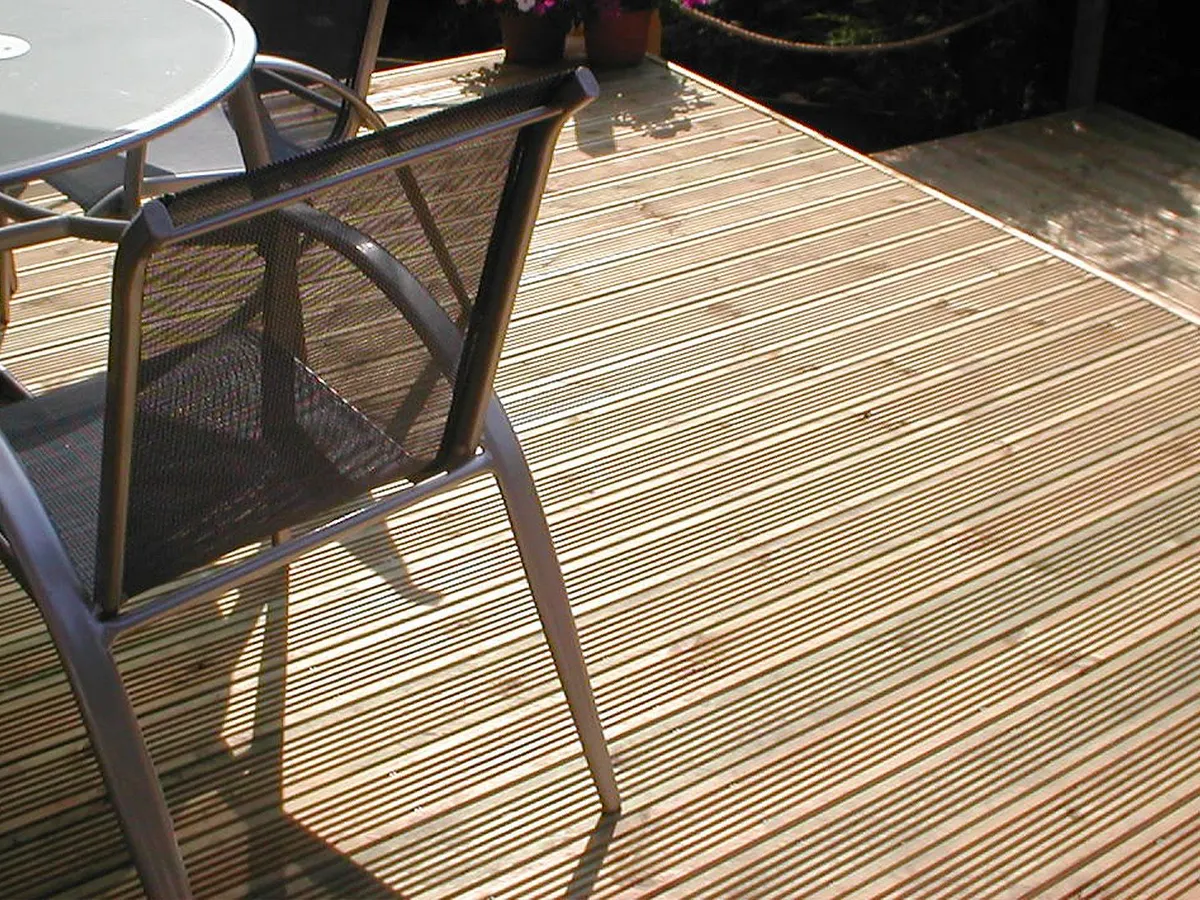 Timber garden deck with a table and chairs