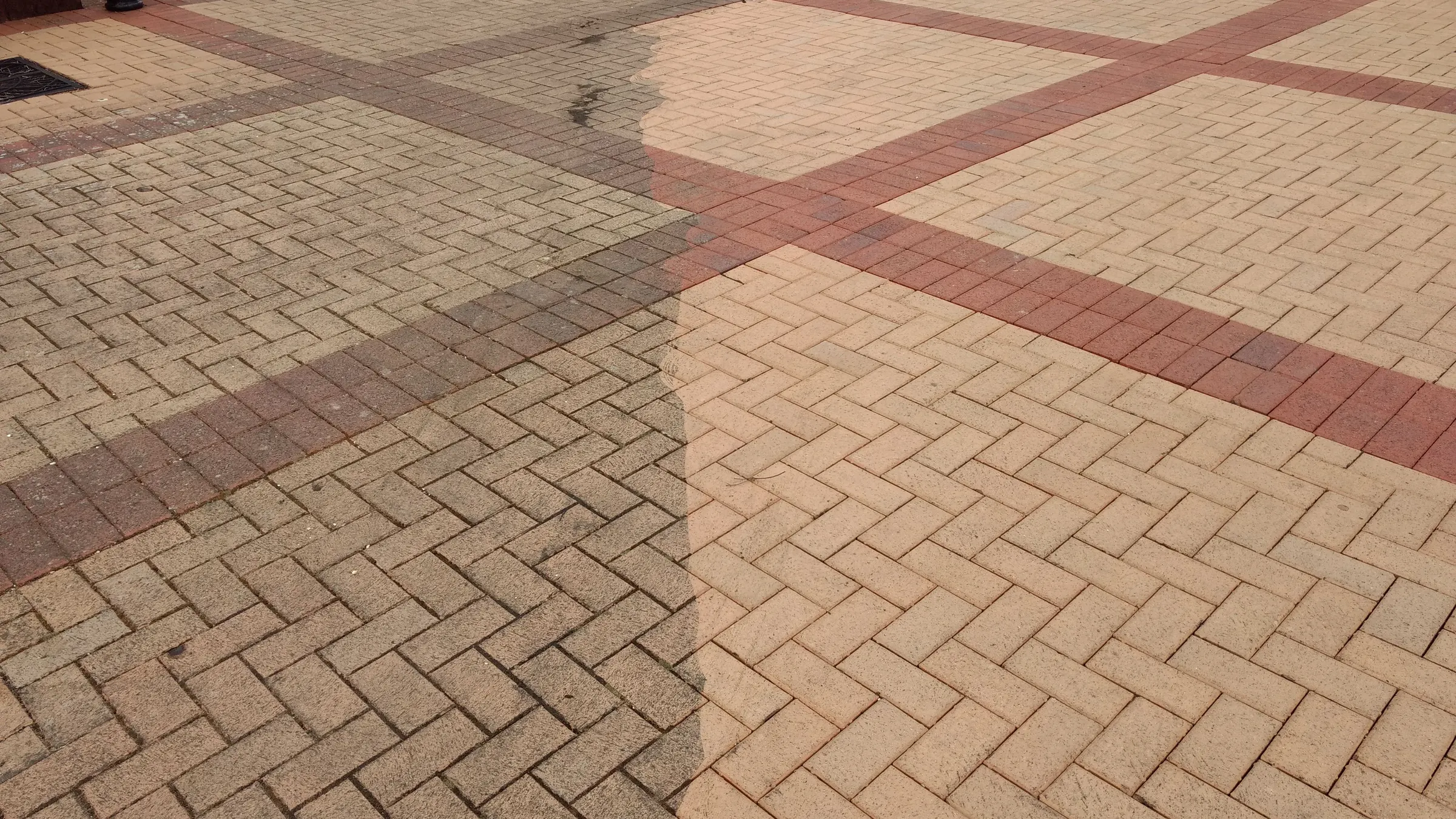 Block paving half jet washed showing clean and dirty sections