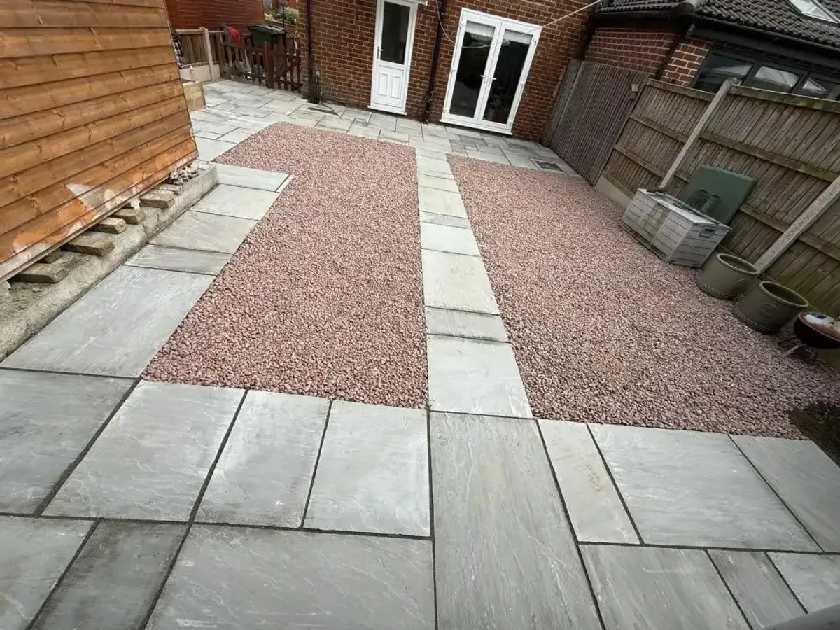 Grey sandstone patio with red gravel strips in Manchester