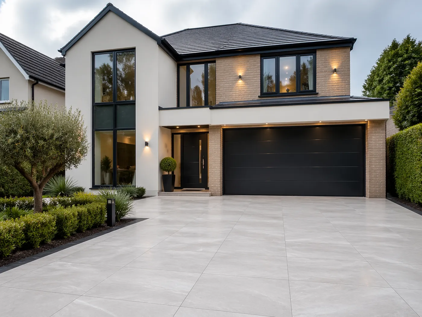 Pale porcelain driveway in front of a modern house with a double garage
