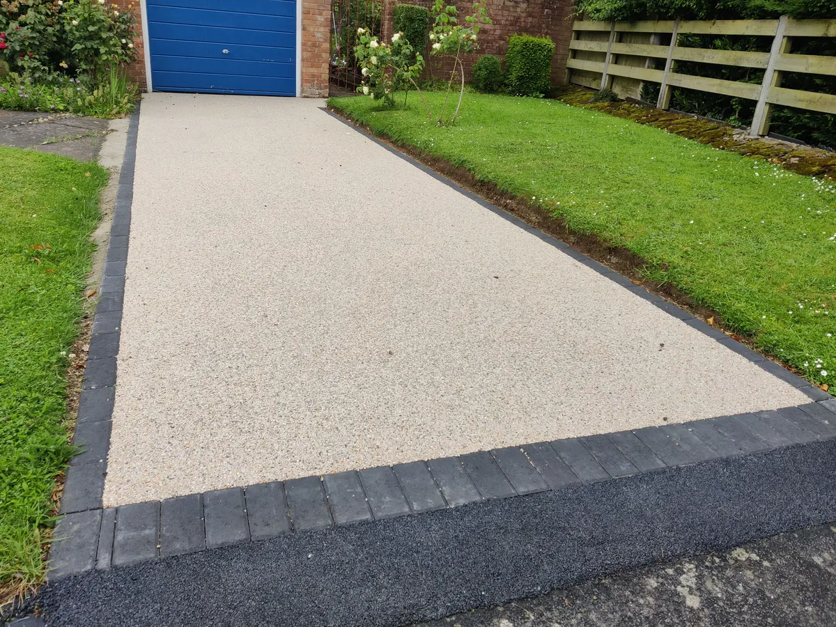 Natural stone resin bound driveway beside a lawn