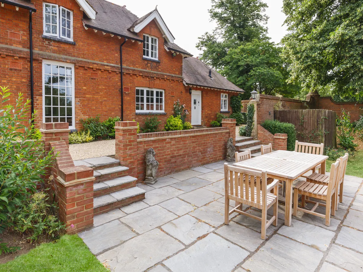 Brick retaining walls and steps around a sandstone patio