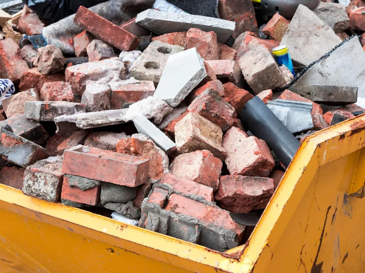 Skip loaded with brick rubble from a clearance